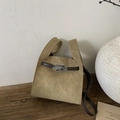 Close-up of minimalist khaki suede tote bag with brown leather trim and silver metal twist lock - Khaki