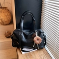 Black PU leather Boston bag with plush charms, double handles and detachable shoulder strap - Black with Pendant