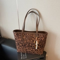 Vintage leopard print tote bag with brown leather straps on a book for office commute - Leopard Print Brown With Pendant