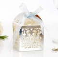 Detail of silver laser-cut hollow candy box featuring floral patterns and a light blue bow - Reflective Silver