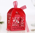 Detail view of red laser-cut lace candy box with elegant floral patterns and ribbon - Pearlescent Red