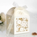 Elegant laser-cut floral wedding favor gift box in white with a delicate organza ribbon bow - Ivory