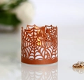 Detailed laser-cut spider web candle sleeve in bright orange for Halloween atmosphere - Antique Bronze