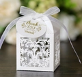 White laser-cut lace wedding favor box with a ribbon bow and a gold thank you tag - Style with Tag