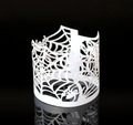 Macro view of white laser-cut spider web paper wraps for Halloween LED tea light candles - White