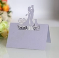 Detailed laser-cut lavender wedding seat card featuring a romantic couple silhouette - Lavender
