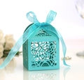 Close-up of laser-cut Tiffany blue candy box with floral patterns and organza ribbon - Tiffany Blue