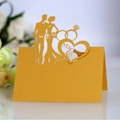 Elegant gold laser-cut wedding place card featuring Mr & Mrs silhouette and heart - Gold
