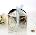 Detail of silver laser-cut candy box with Love heart hollow design and blue ribbon bow - Reflective Silver