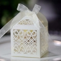 Detail showing the intricate laser-cut floral pattern and ribbon on white gift box - Ivory