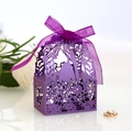 Macro shot of purple laser-cut wedding favor box with ribbon bow and couple silhouette - Dark Purple