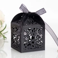 Detail view of black laser-cut candy box with floral patterns and organza ribbon bow - Black Khaki