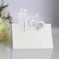 Laser-cut white pearlescent paper wedding place card with Mr & Mrs silhouette design - Ivory