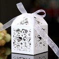 Elegant white laser-cut wedding favor box with floral patterns and a satin ribbon bow - White