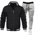 Detail eines Freizeit-Trainingsanzugs für Herren mit schwarzer Jacke und grauer Jogginghose - Schwarzes Oberteil Mit Hellgrauer Hose