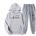 Detail of light gray hoodie and joggers set featuring black heart print and soft fabric - Light Gray
