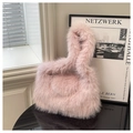 Detail of pink faux fur tote bag with soft plush texture and ring handle structure - Pink