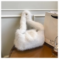 Detail of soft white faux fur tote bag showing plush texture on a stylish table - White