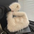 Minimalist beige faux fur tote bag with fluffy plush texture on a black book background - Khaki