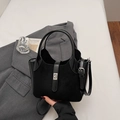 Matte black bucket bag with silver buckle and adjustable strap in a stylish flat lay view - Black without Pendant