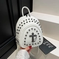 Detail of white leather mini backpack with gothic metal rivets and cross pendant - White