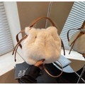 Detail of plush cream bucket bag featuring brown leather drawstring and textured faux fur - Off White