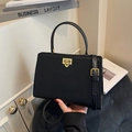 Classic black leather-textured handbag with gold square buckle and adjustable strap - Black
