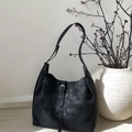 Detail of a vintage black hobo bag with a matte texture and silver buckle strap - Black