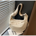 Minimalist beige canvas half-moon hobo crossbody bag with adjustable strap and tassels - Off-white
