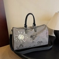 Grey canvas travel bag with playful white doodle patterns and black leather handles - Gray