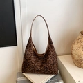 Retro leopard print hobo shoulder bag with brown strap on a minimalist setup - Brown