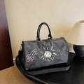 Dark gray canvas travel bag featuring artistic graffiti prints and black leather handles - Black
