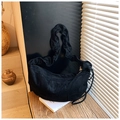 Detail of black suede crescent bag featuring ruffled shoulder strap and side fringe - Black