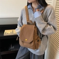 Brown canvas flap backpack for women featuring yellow button and side drawstring pockets - Brown