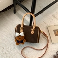 Deep brown frosted suede Boston bag with leather handles and a brown plush bear charm - Small Coffee With Charm