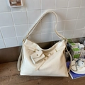 Close-up of cream white hobo tote bag with gold chain and mini coin pouch detail - White