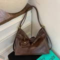 Detailed close-up of a vintage brown leather tote bag with white stitching and mini pouch - Brown