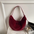 Chic burgundy faux fur hobo bag with leather strap on an elegant aesthetic background - Burgundy