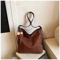 Detail of brown suede tote bag with cute teddy bear charm on minimalist background - Coffee with Pendant