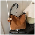 Caramel suede bucket bag with black leather strap and brown plush bear charm detail - Brown with Pendant