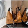 Detail der Retro-Wildleder-Schultertasche mit glänzendem Riemen und Magnetverschluss - Braun