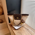 Beige tote bag with brown quilted pocket and golden chain strap in a warm sunlit room - Khaki with Pendant