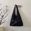 Minimalist black fabric triangular shoulder bag with leather straps and silver hardware - Black