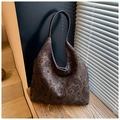 Detail of paisley canvas tote bag with brown leather straps on a wooden step - Dark Green