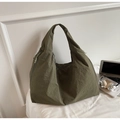 Detail of olive green crescent tote with pleated texture and side drawstring for daily commute - Green
