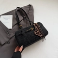 Detail of black suede tote bag with gold buckle, brown letter charm, and braided knot - Black (with Pendant)