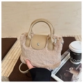 Close-up of light brown faux fur handbag with leather flap and magnetic buckle closure - Khaki