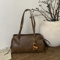 Dark brown retro tote bag in textured leather with gold buckles and wooden bead charm - Brown with Pendant