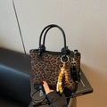 Chic leopard print bucket bag with black leather straps and wooden bead charm detail - With Pendant / Black