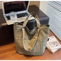 Grande borsa tote in nylon kaki presentata in un ambiente quotidiano lifestyle - Verde